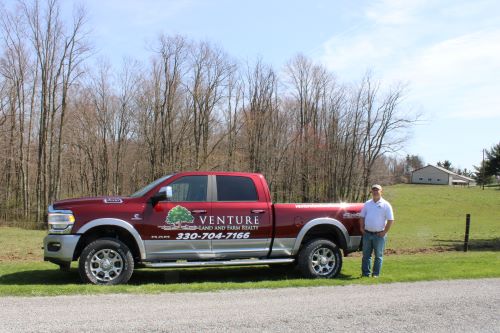 Eric Knotts standing next to company truck